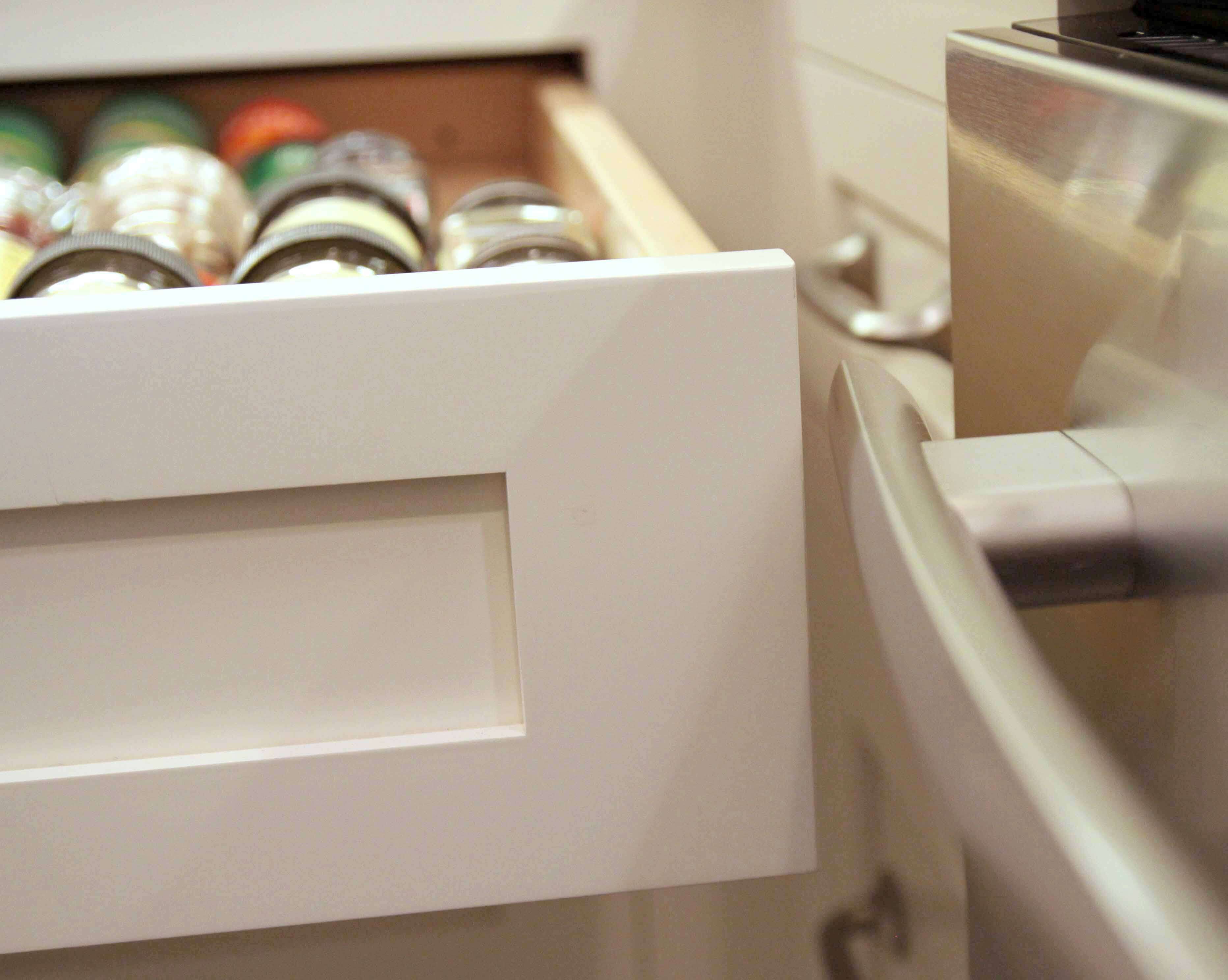 A kitchen drawer in the corner was designed to have enough space to clear the appliance handle with out colliding into it.