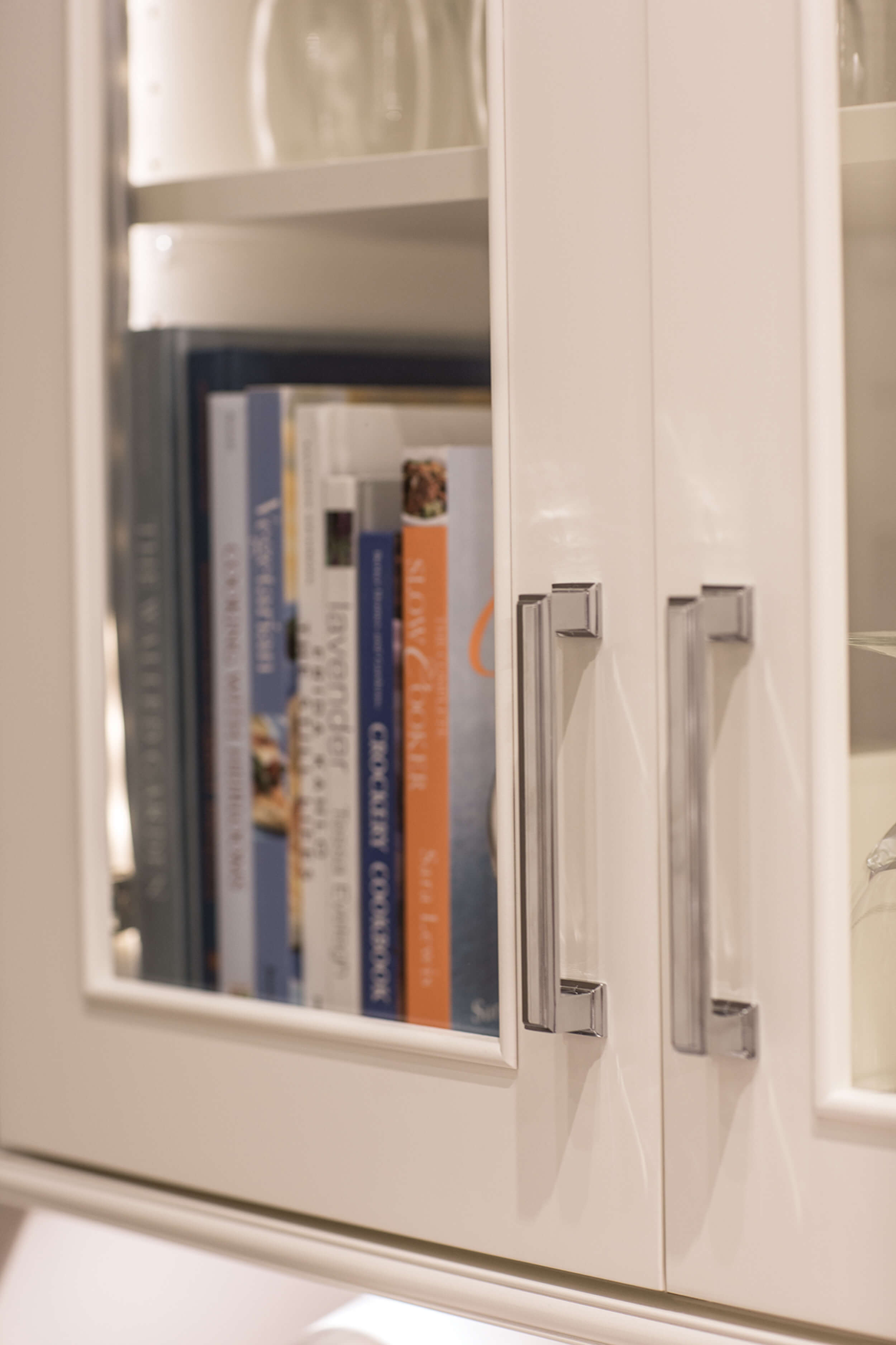 A close up of glass cabinet doors with a molding detail around the inside panel.