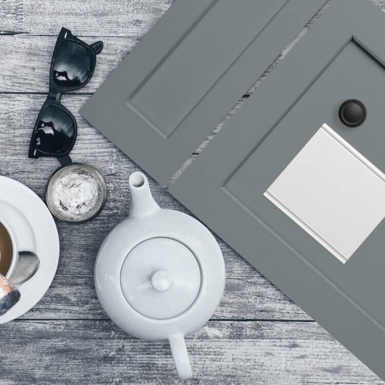 A mood board with dark gray painted cabinet door with a shaker style.