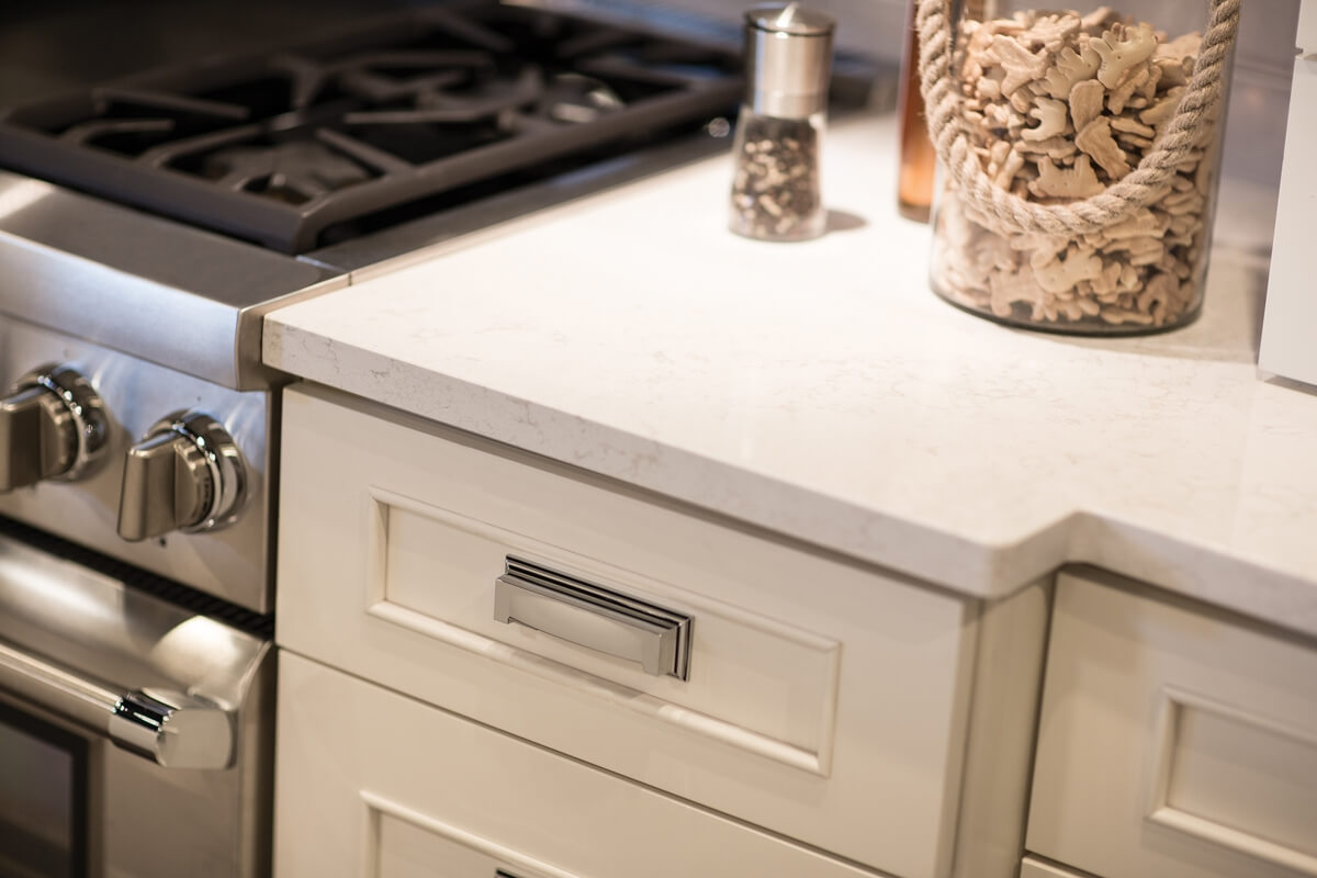 Dura Supreme Cabinetry shown in the Silverton door style with a Classic White finish with Cambria 