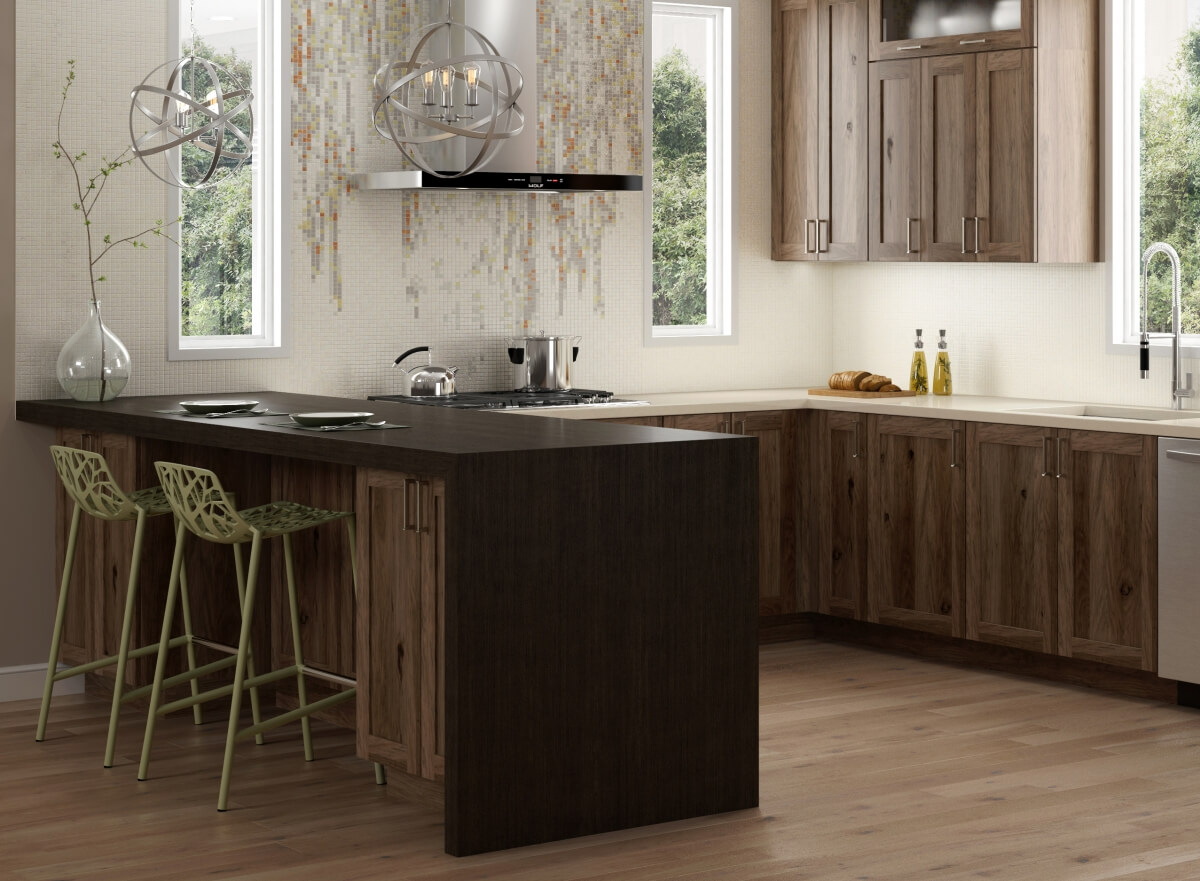 The end of the peninsula had a black waterfall countertop that contrasts the gray stained hickory kitchen cabinets.