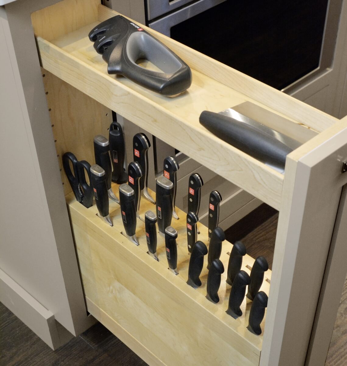 A Knife Block Pull-Out Cabinet using the top tier for misc. food preparation tools.