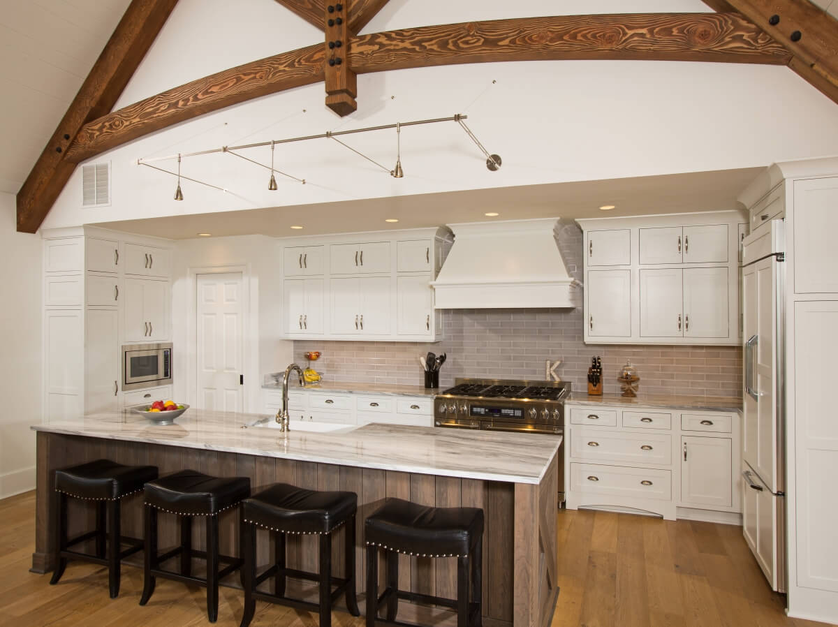 Light and dark cabinetry warmed with wood floors. Homestead Panel Inset Door Style in White Paint and Cherry Weathered D