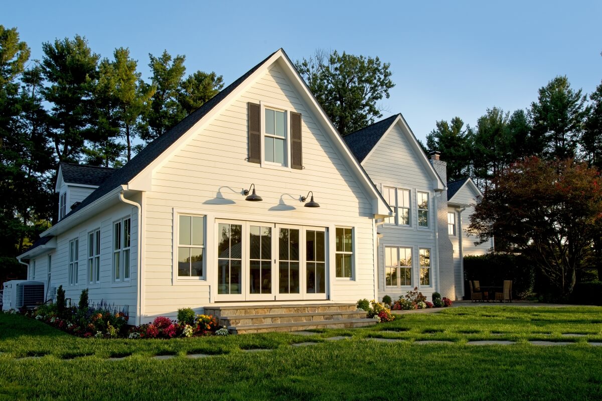 A classic white exterior with black accents and industrial style lighting