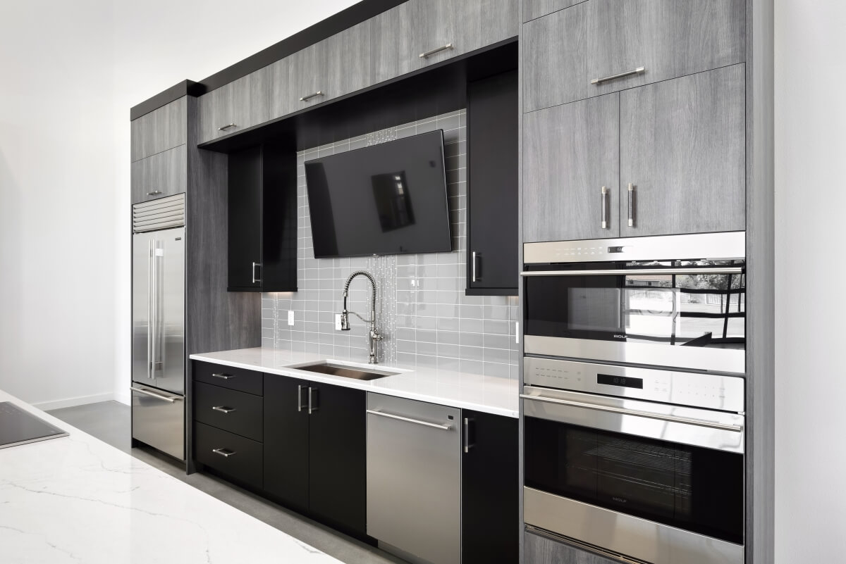 Simple, contemporary styled molding was selected with a Black paint finish to frame the wall and tall cabinet to make them appear as one unit.