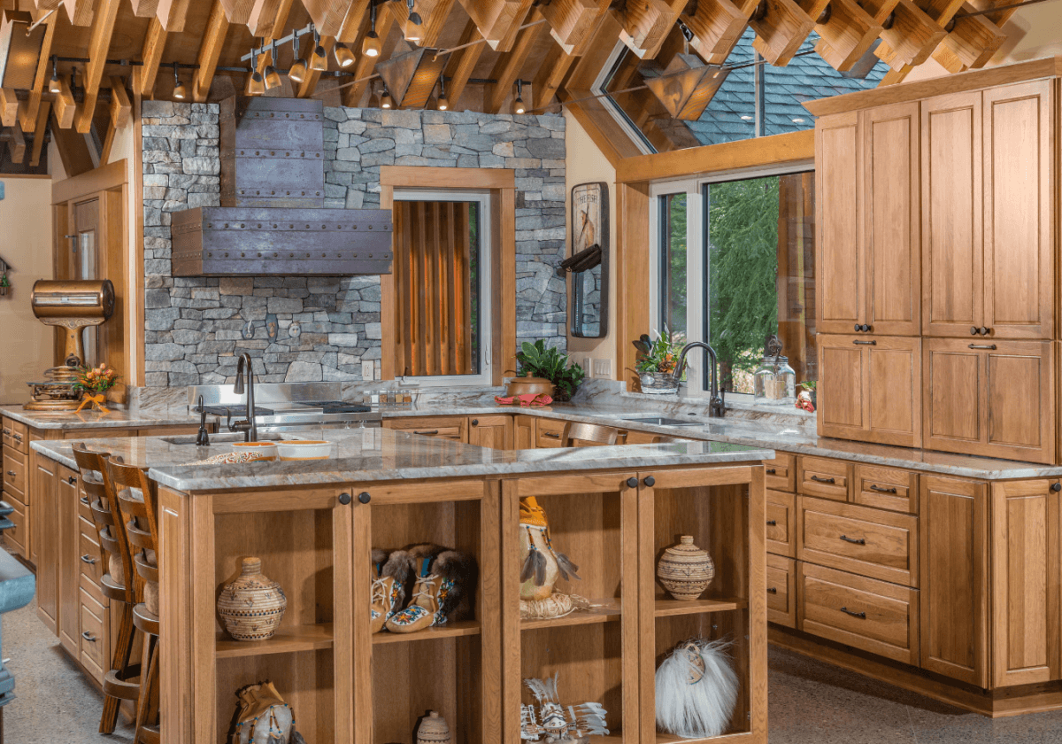 A stunning mountain lodge inspired kitchen, featuring a gorgeous hand-made copper range hood and Dura Supreme Cabinetry. Kitchen designed by Hollie M. Ruocco, CMKBD of Creative Kitchen Designs, Inc and photographed by DMD Photography. Door style: Chelsea in Hickory with Butternut finish.