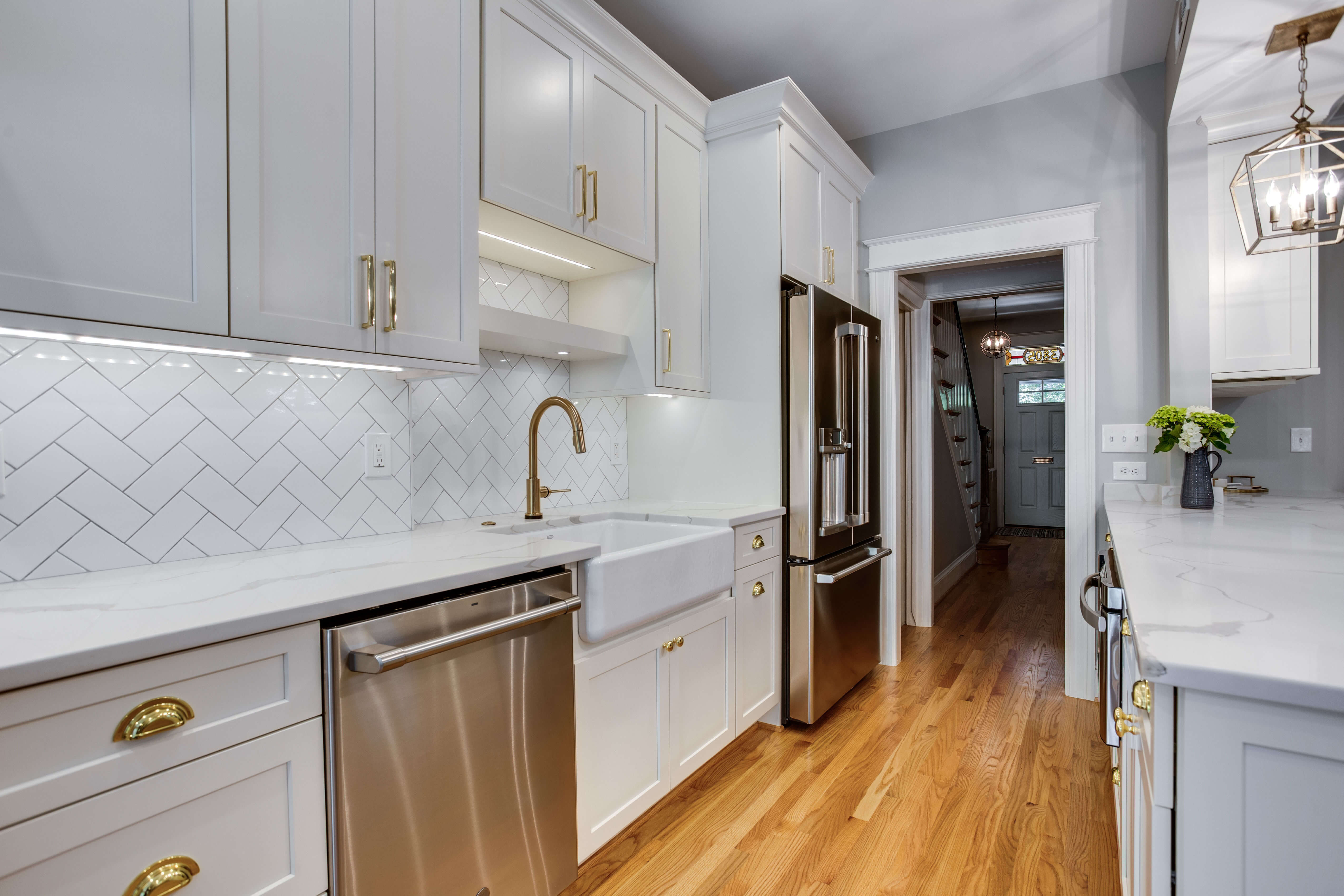 Photo of the beautiful backsplash design that Marissa Shipe suggested for the homeowners kitchen remodel. The design features classic subway tile in a herringbone pattern.