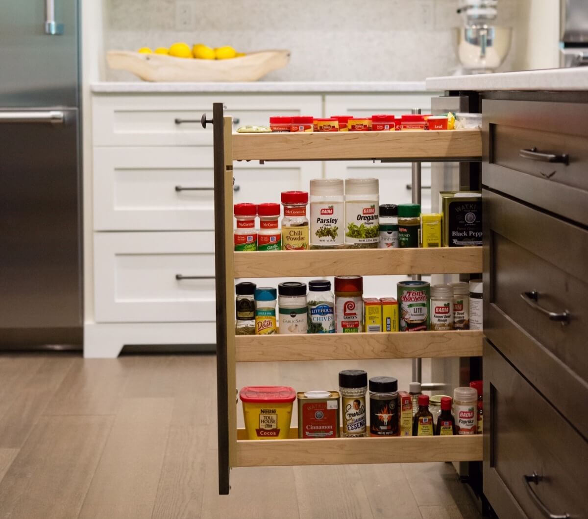 Kitchen Design by Megan Courtney of Cabinet Style, LLC featuring a Base Pull-Out Cabinet with Spice Rack shelves by Dura Supreme.