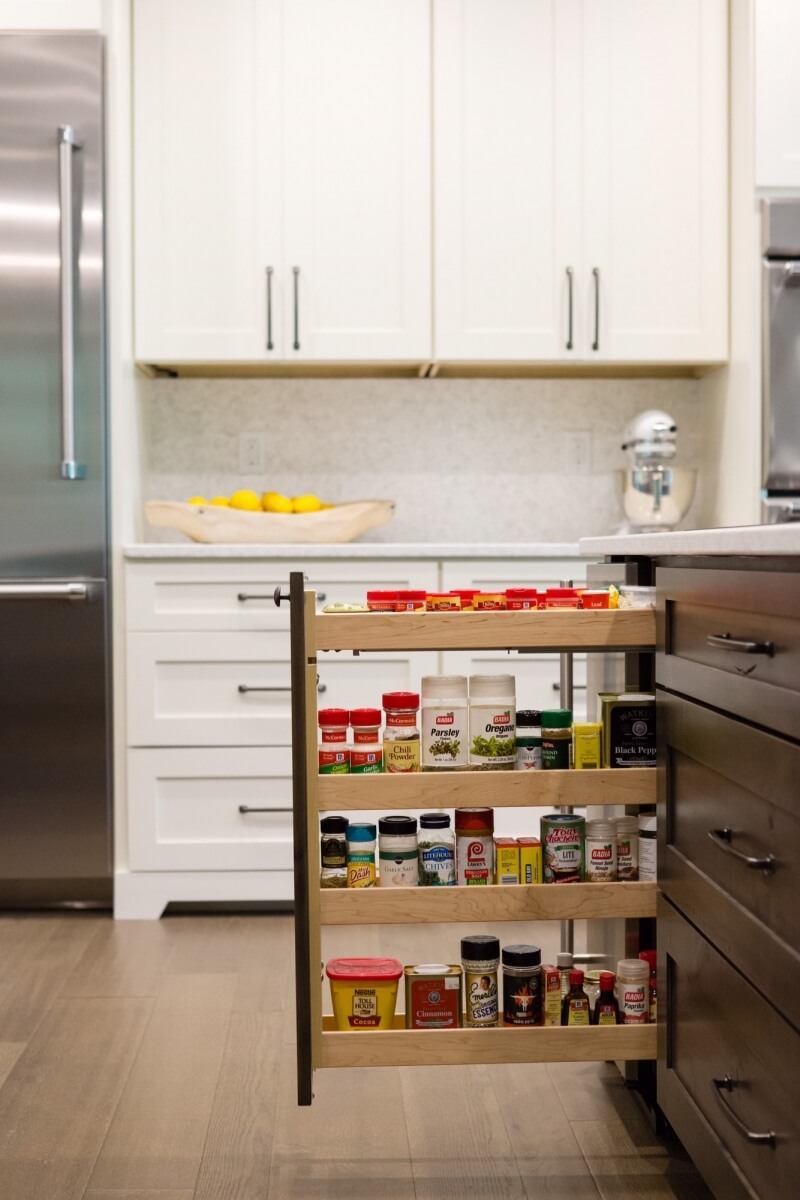 Kitchen Design by Megan Courtney of Cabinet Style, LLC featuring a Base Pull-Out Cabinet with Spice Rack shelves by Dura Supreme.