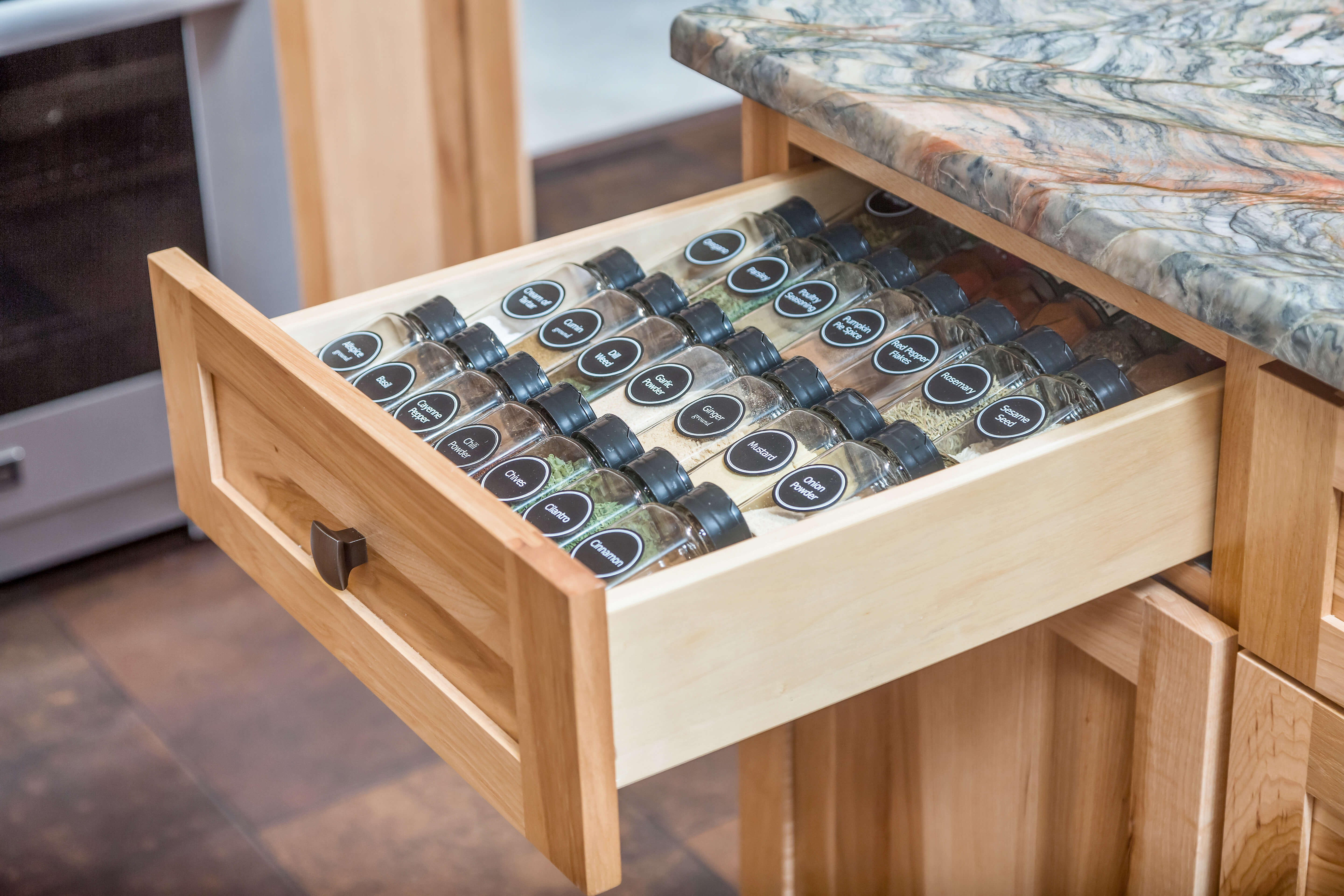 Design by Danielle Bohn, CKBD of Creative Kitchen Designs, Inc., Alaska featuring Dura Supreme Cabinetry Spice Rack Drawer. Photo by Dave M Davis Photography.