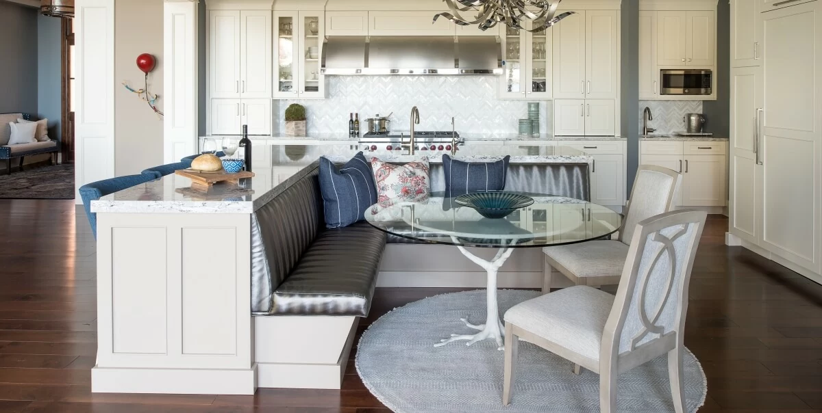 An L-Shaped Kitchen Island with a Breakfast Nook. Dura Supreme Cabinetry design by Michels Homes. Photo by Landmark Photography.