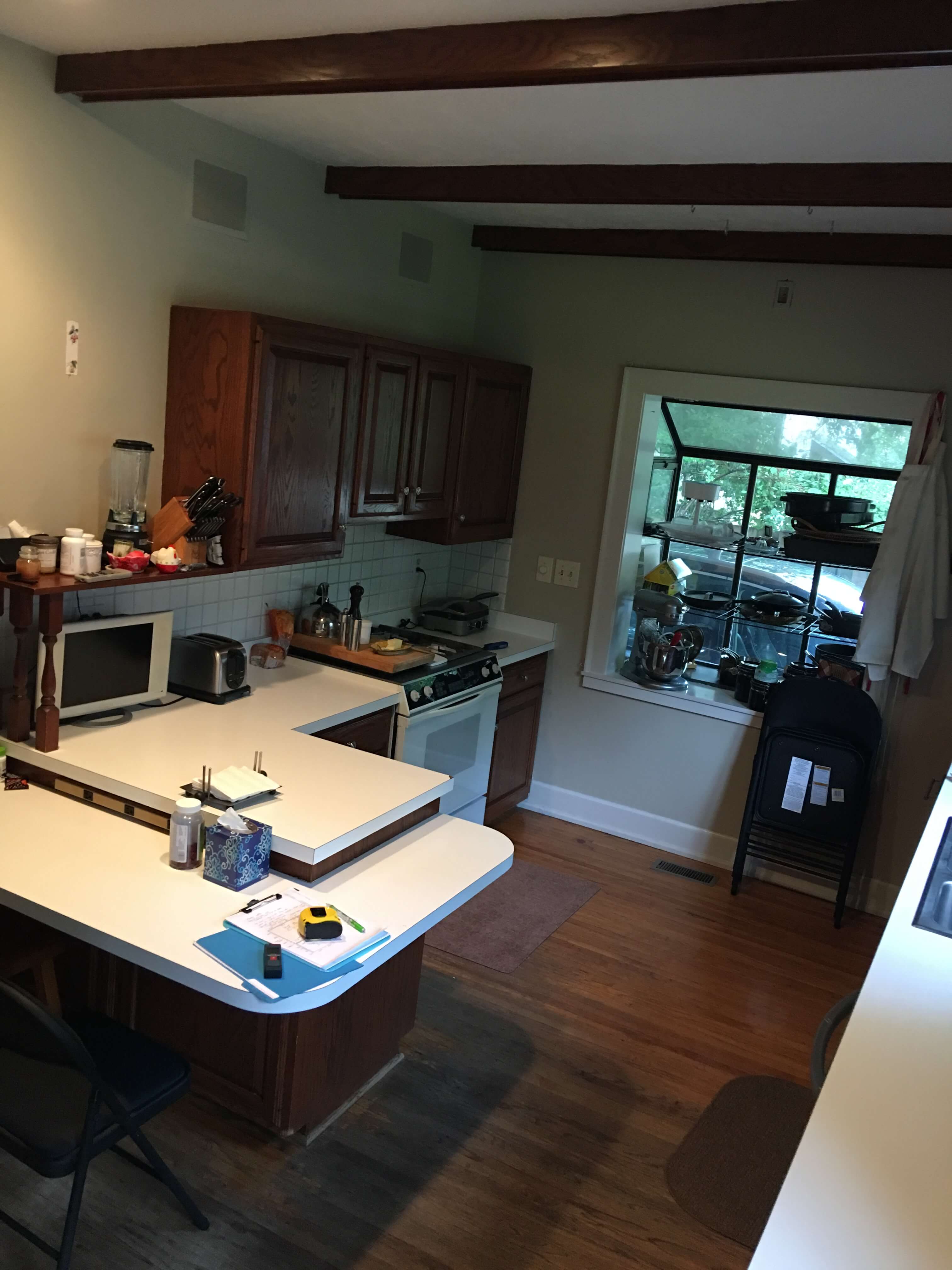 Before remodel photo of a dark outdated kitchen in a historic home.