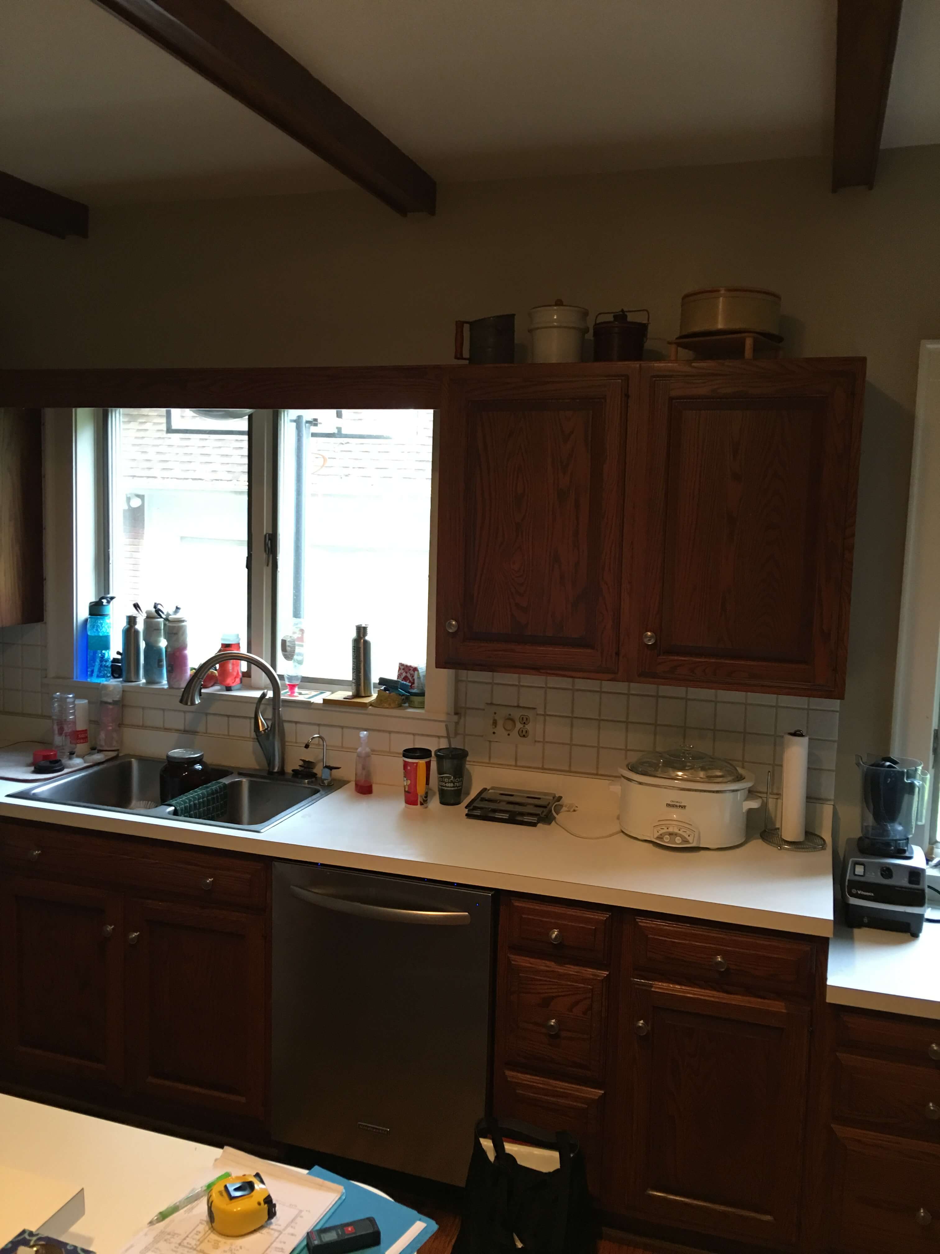 Before remodel photo of a dark outdated kitchen in a historic home.