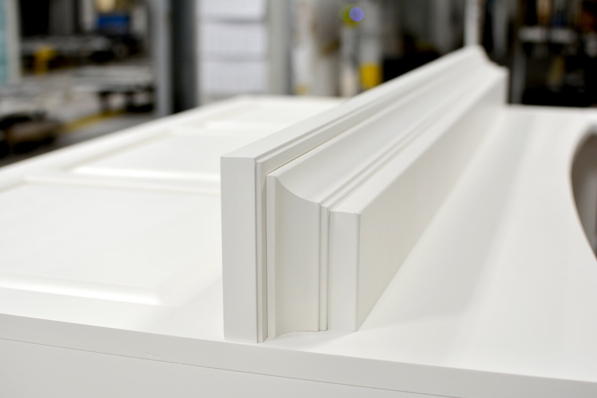 A close up of a wood hood being assembled on the Dura Supreme Cabinetry factory floor.