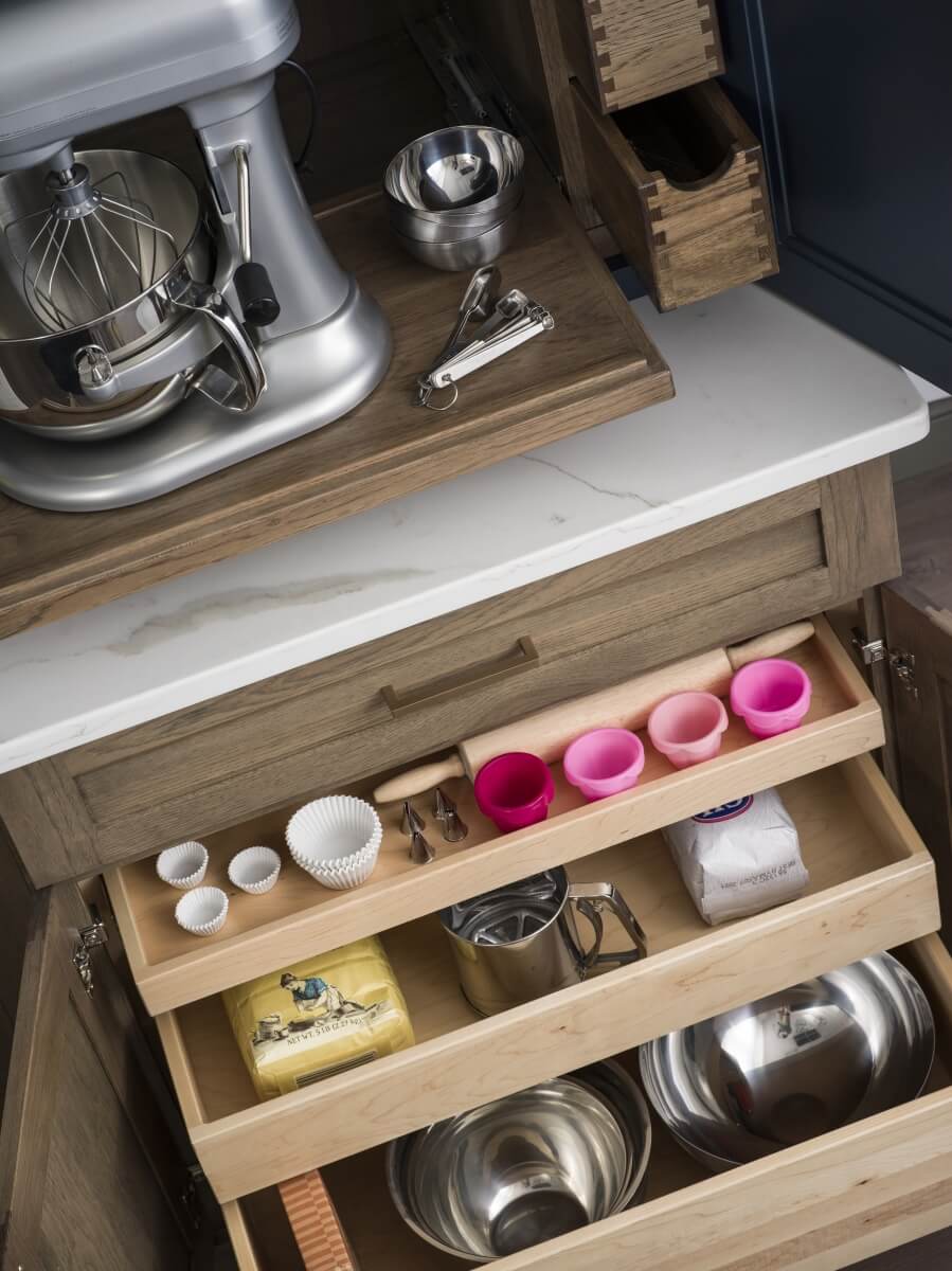 Roll-out shelves in a base cabinet for easy accessible storage. Kitchen cabient storage solutions from DUra Supreme Cabinetry.