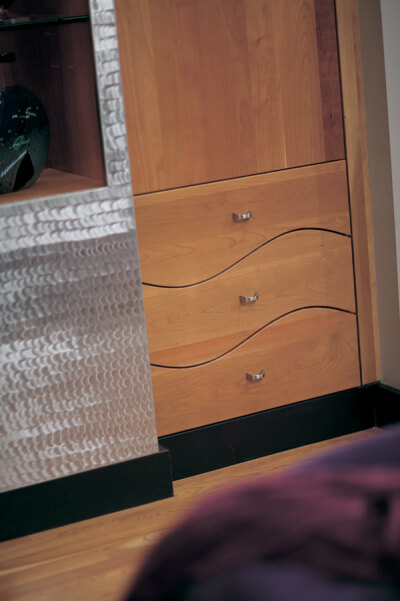 Custom-designed, wavy drawer fronts add additional interest to this Dura Supreme entertainment center.