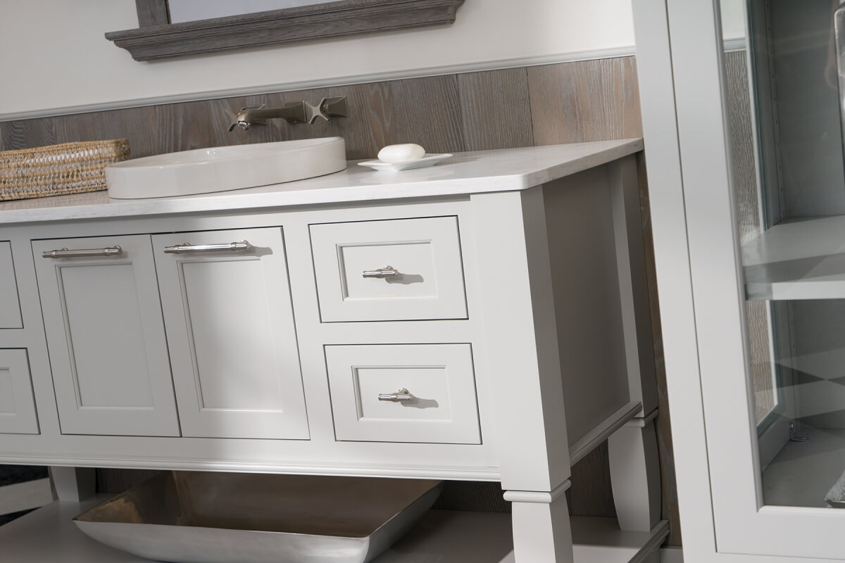 A close up of a light gray painted vanity.