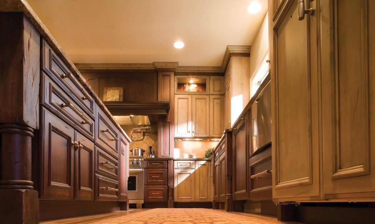 A mixture of two different kitchen cabinet woods and finishes in a mountain resort styled kitchen design.