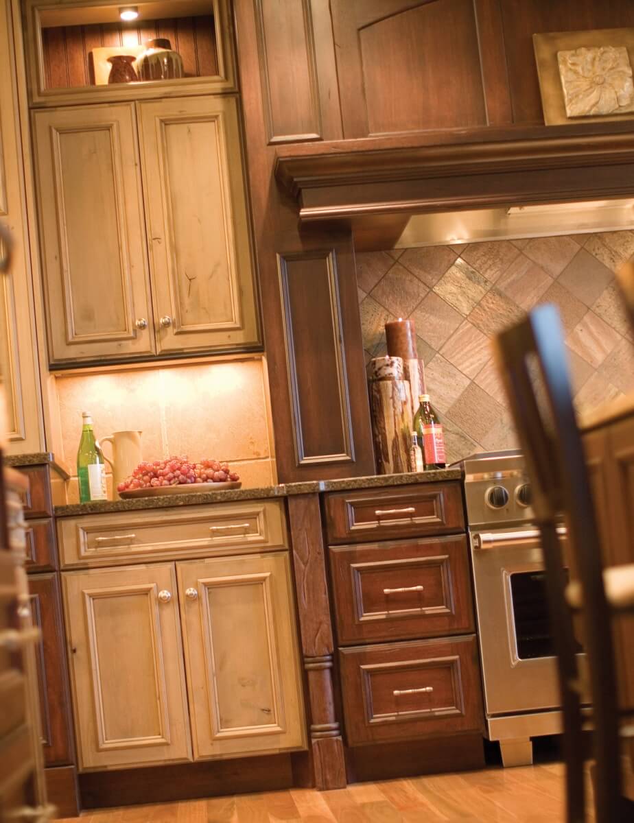 A mixture of two different kitchen cabinet woods and finishes in a mountain resort styled kitchen design.