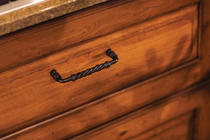 Traditional and rustic styled cabinet hardware pull on a mountain resort style kitchen cabinet drawers.