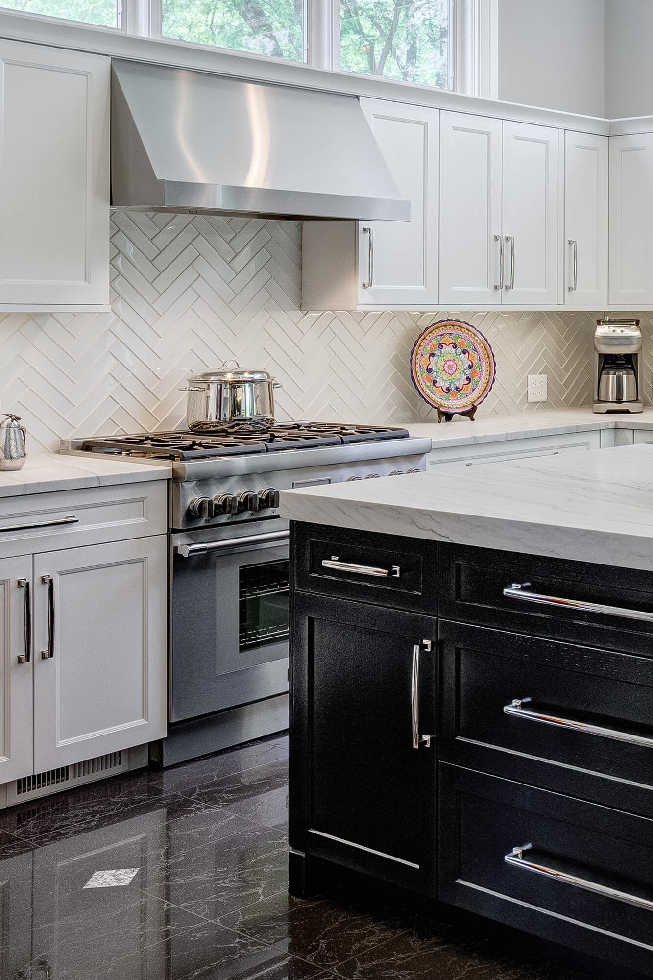 A white and black kitchen design with a cool color palette and white painted cabinets.
