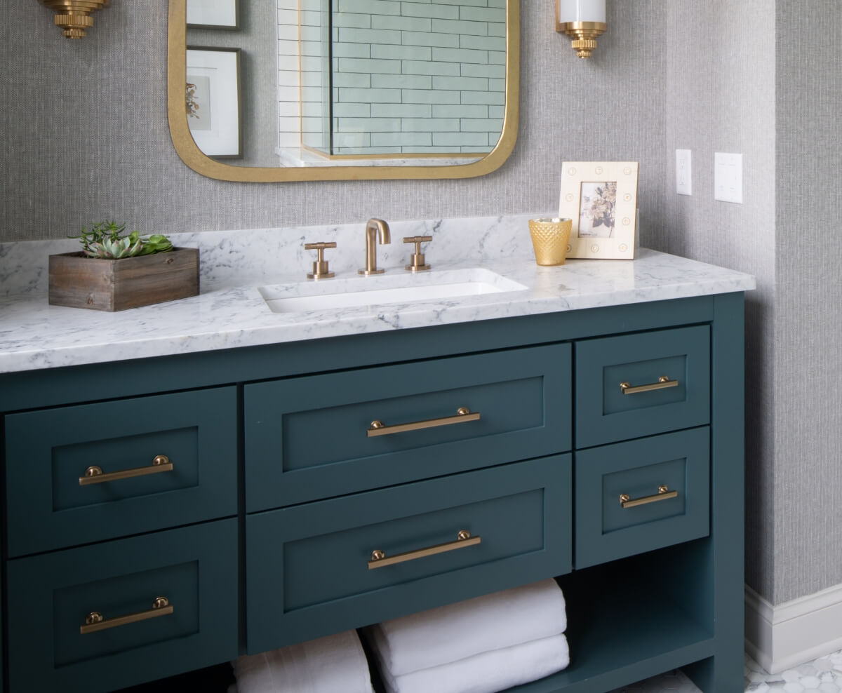 This stately bathroom with brass accents was designed by Studio M Kitchen & Bath and Interior Design by Studio M Interiors, Minnesota.