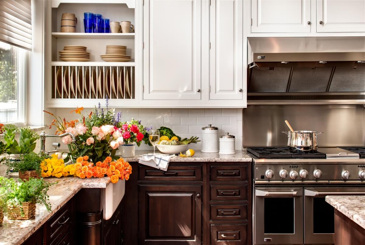 A cozy lake house kitchen design featuring Dura Supreme Cabinetry's Arcadia Classic-Inset door in a combination of 