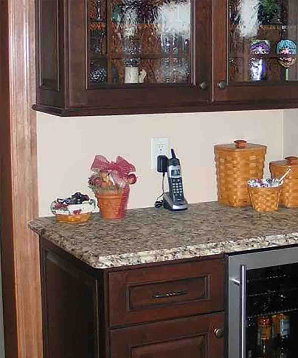 In addition to the light rail molding and the countertop extending over the door casing on the left - the countertop extends beyond the wall on the right.