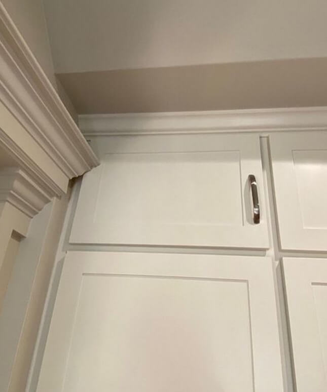 In this kitchen fail, the structural door frame molding blocks the cabinets from opening.