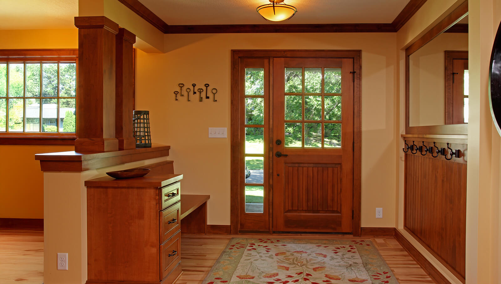 A Craftsman styled entryway with a built-in Dura Supreme boot bench. Design by Kristen Peck of Knight Construction Design, Inc., Minnesota.