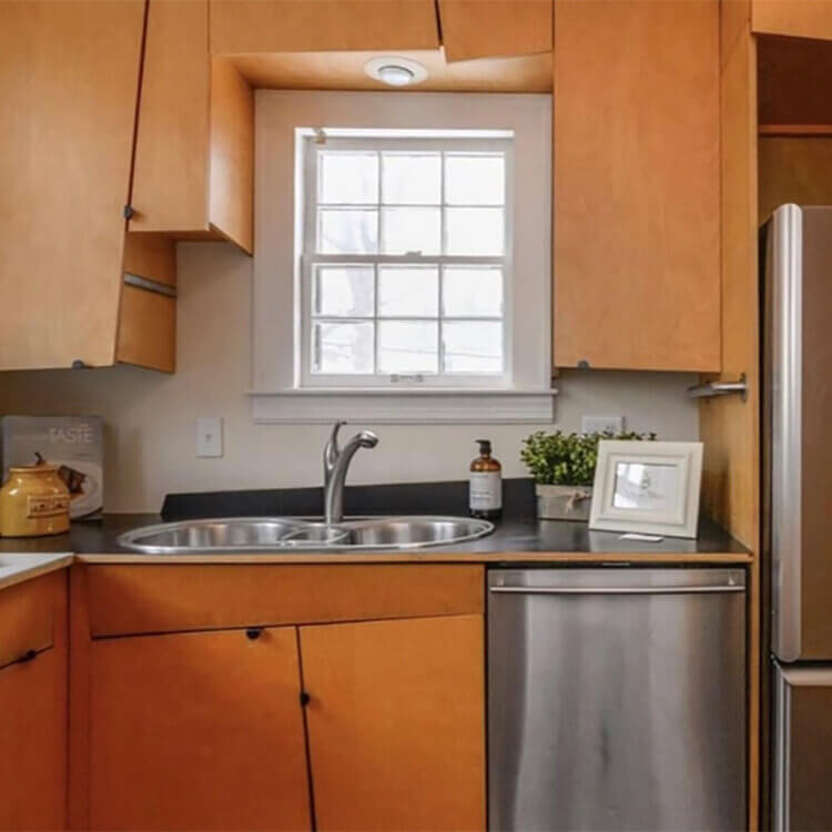A terrible kitchen design with strange shaped cabinets and poor storage.