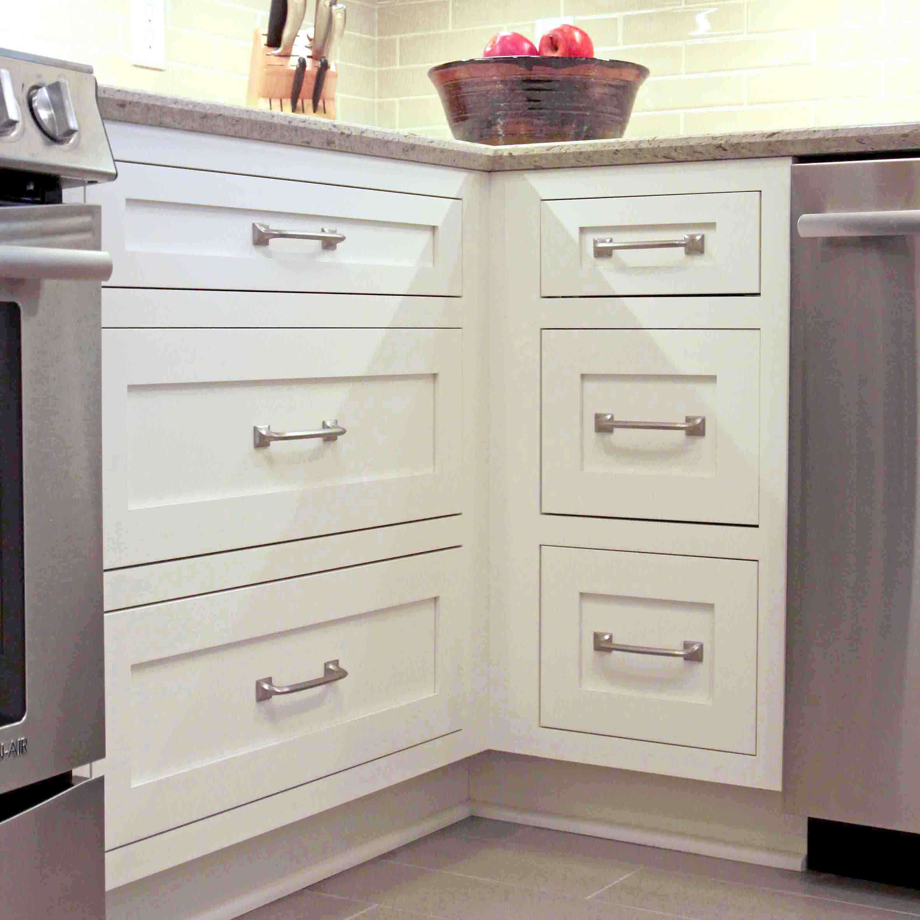 A voided corner in a kitchen design with drawers on each side.