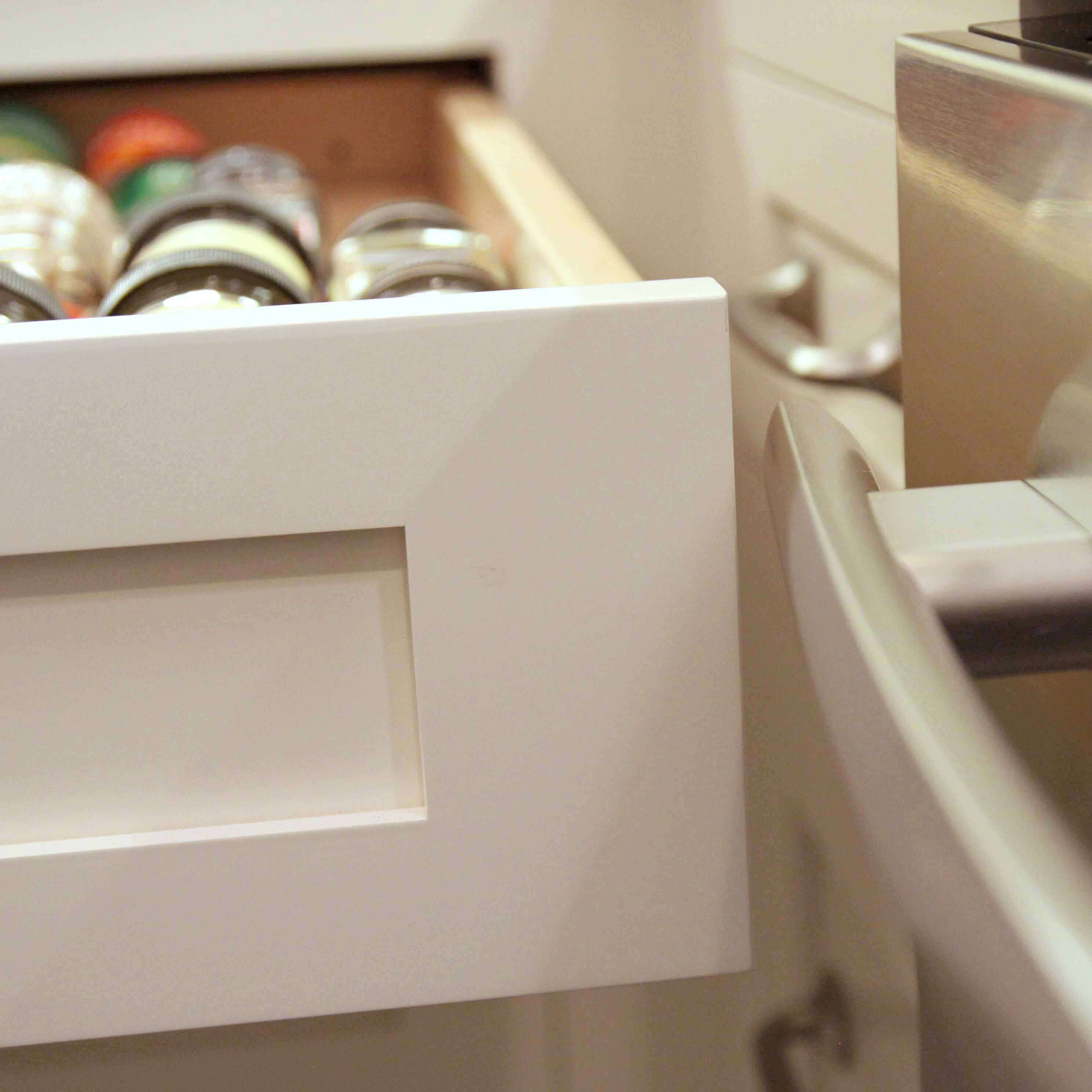 A kitchen drawer in the corner was designed to have enough space to clear the appliance handle with out colliding into it.