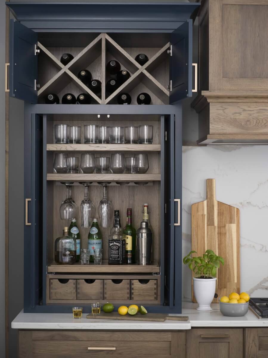 Dura Supreme Cabinetry Beverage Center Larder shown used for home bar storage.