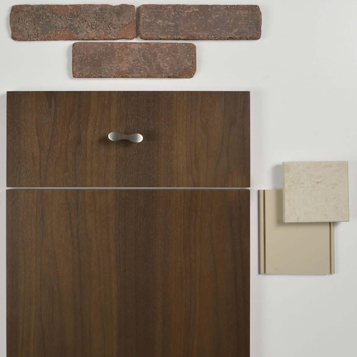 An industrial style mood board with a slab styled walnut cabinet door, samples of red brick backsplash tiles, and an off-white, beige paint and countertop sample.