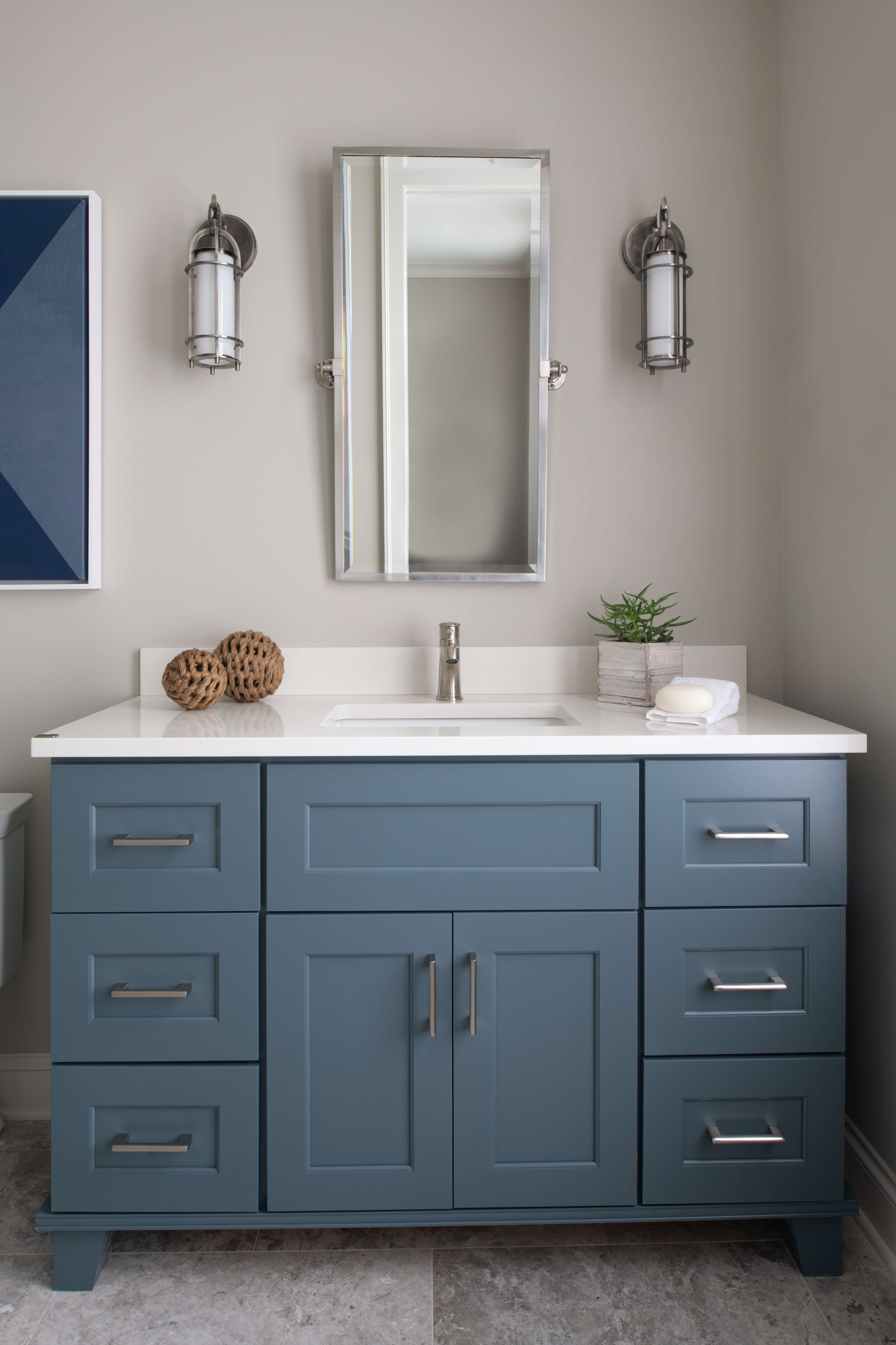 Dura Supreme Furniture Vanity with a blue paint finish and a white countertop.