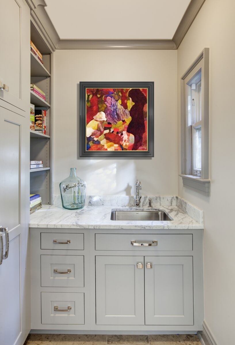 A bright and welcoming butler's pantry and sink nook with light gray painted cabinets and white painted walls.