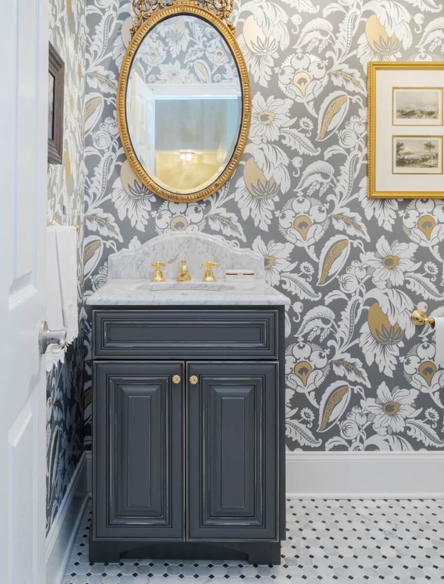 A traditionally styled shabby chic bathroom. With a small bathroom vanity featuring a rustic and distressed gray painted finish.