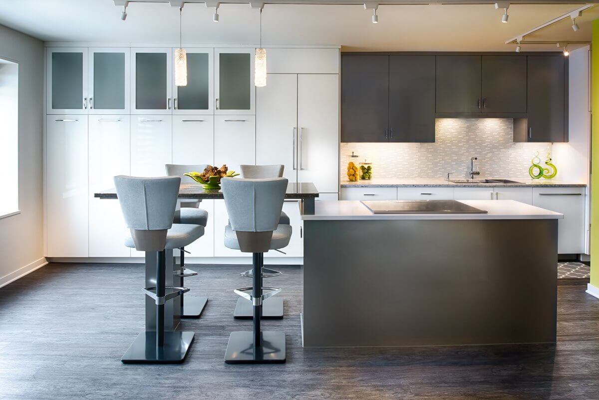 A modern and contemporary styled kitchen with gray and white painted cabinets and vibrant lime green color accents.