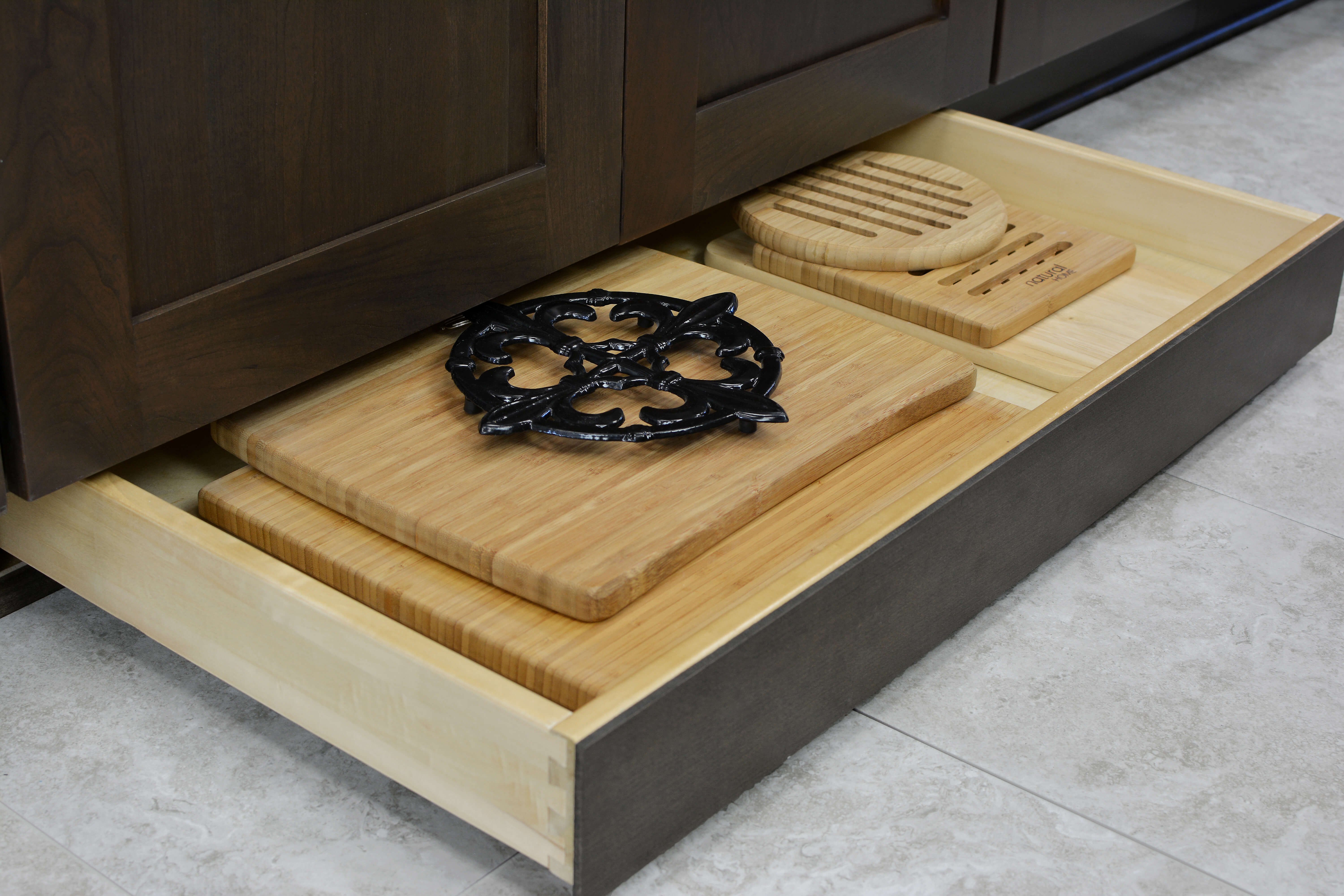 Miscellaneous items can find a home in a Dura Supreme Toe-Kick Drawer hidden at the foot of your cabinets. This convenient solution adds additional storage to your home. It’s great for storing your cutting boards, trivets, rolling pins, and much more!