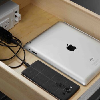 A cabinet drawer with an outlet for powering and charging devices. Any Dura Supreme drawer or roll-out shelf can have a Power Station added to provide a space to charge your devices or power an appliance or equipment.
