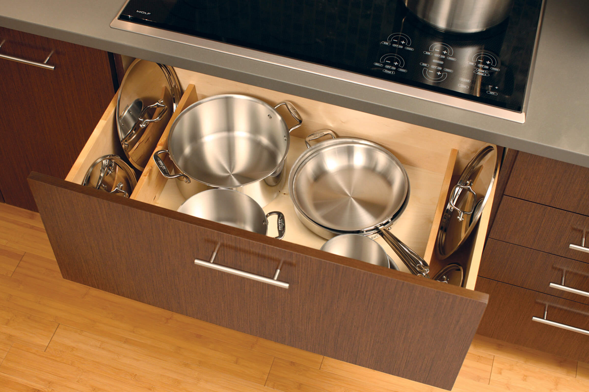 How to organize pot and pan lids with organized kitchen cabinet drawers. Lid Storage Partition storage accessory by Dura Supreme Cabinetry.