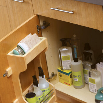 Sink base cabinet with a cabinet door rack for organizing cleaning supplies under the kitchen, bathroom, or laundry room sink.