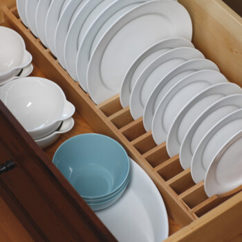 A Plate Rack Drawer from Dura Supreme creates a convenient location and a unique way to store an entire set of dishware within easy reach.