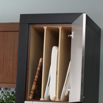 A kitchen cabinet tray divider for tray or cutting board, tray, and pan storage shown in an upper wall cabinet.