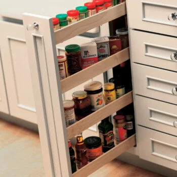 Small spaces offer a surprising amount of spice storage with a vertical Pull-Out Spice Rack. Kitchen Storage idea for spices and small pantry items from Dura Supreme Cabinetry.