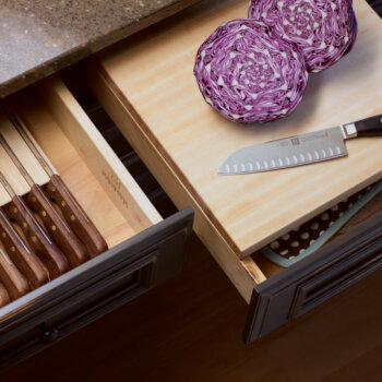 A chop block with drawer and drawer knife holder placed side by side to optimize the food prep process.