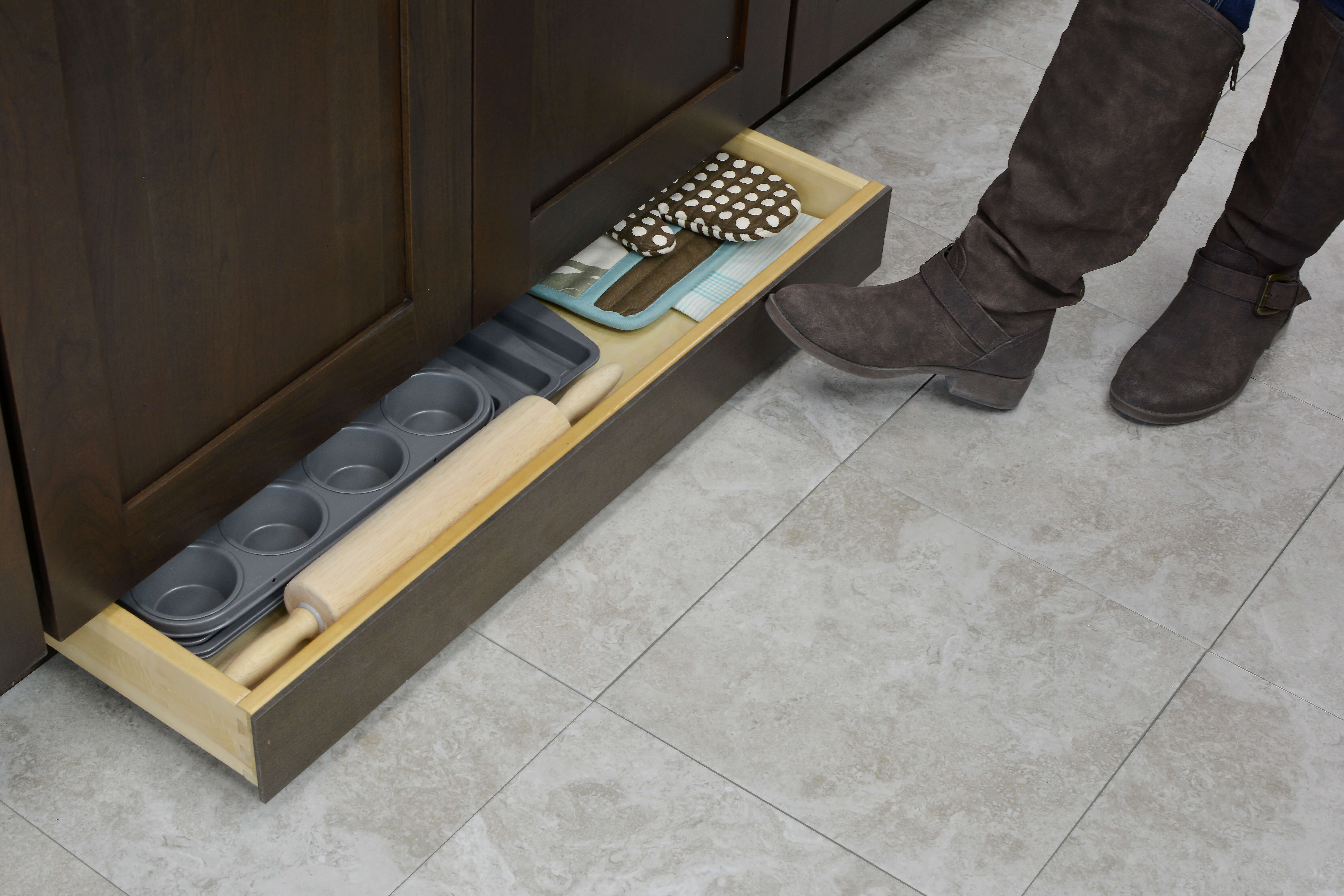Miscellaneous items can find a home in a Dura Supreme Toe-Kick Drawer hidden at the foot of your cabinets. This convenient solution adds additional storage to your home. It’s great for bakeware, spare oven mitts, rolling pins, cutting boards, and so much more!