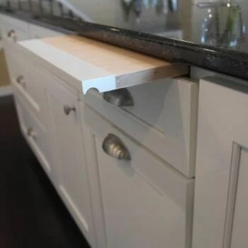 Dura Supreme Cabinetry Kitchen Bread Board in a base cabinet that hides just under the countertop.