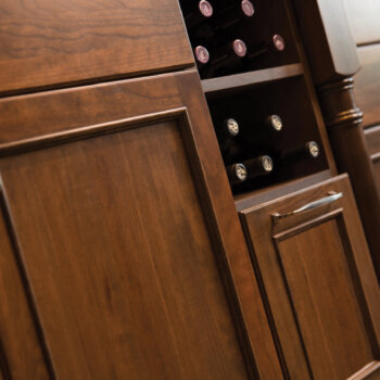 An open cabinet for wine bottle storage with a deep drawer below.